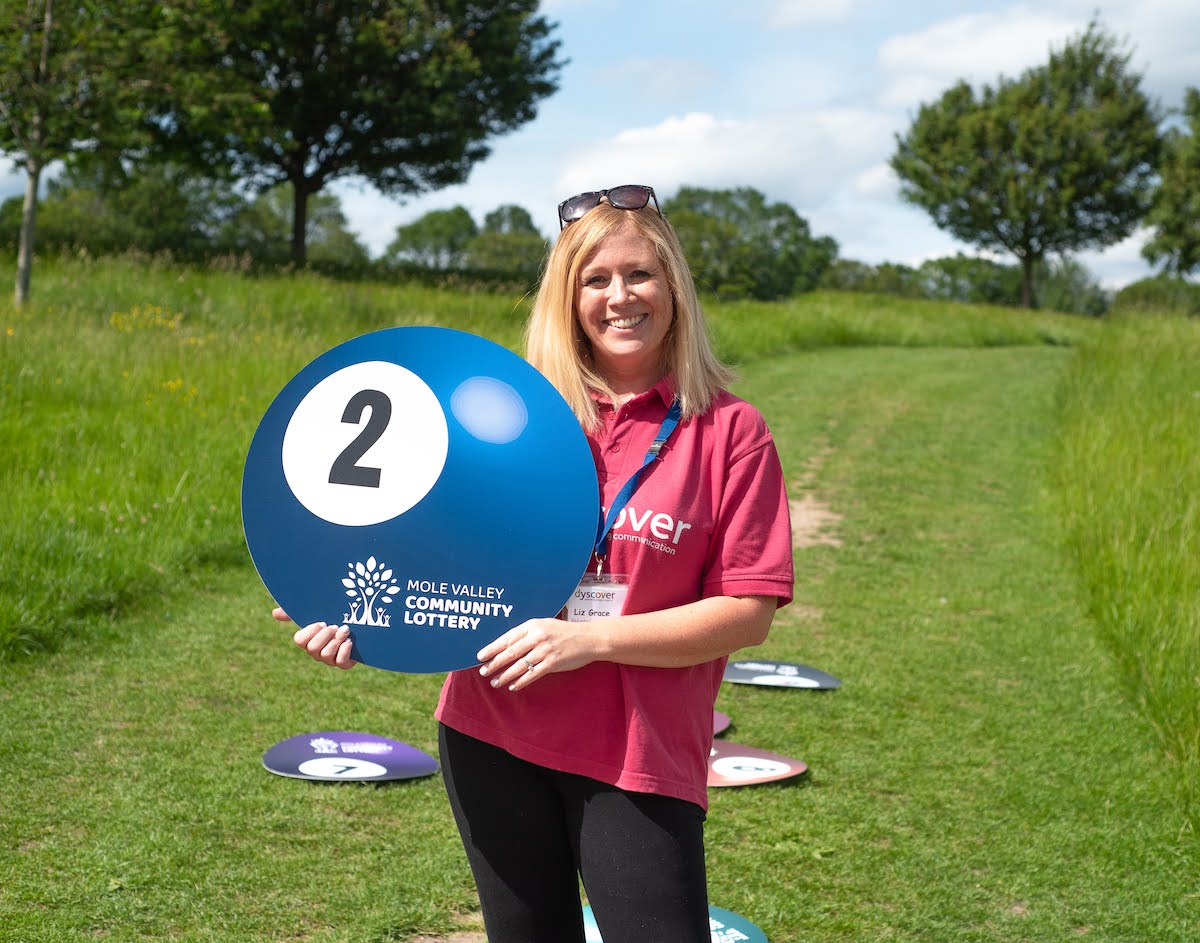 Dyscover Representative holding lottery ball at the launch of the lottery.
